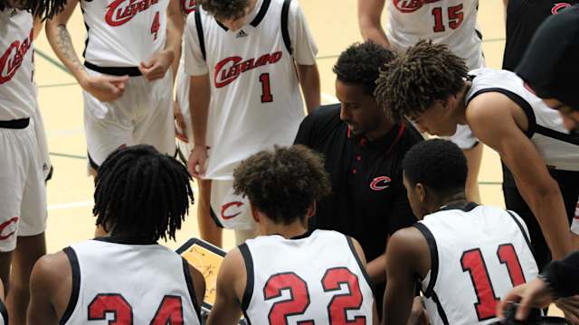 Cleveland coach Dagem Asfaw leads the huddle during a game at the Classic at Damien